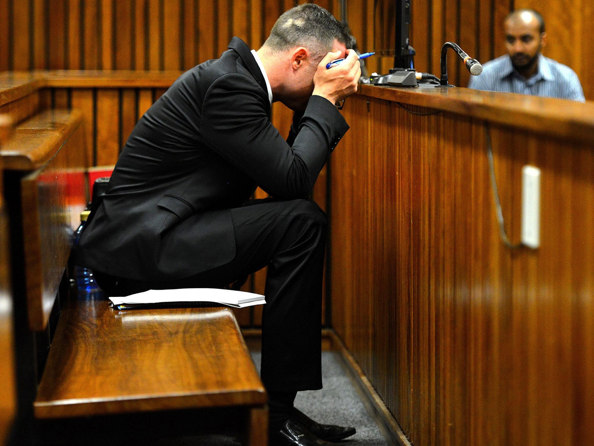 Oscar Pistorius sits in the dock at the high court in Pretoria