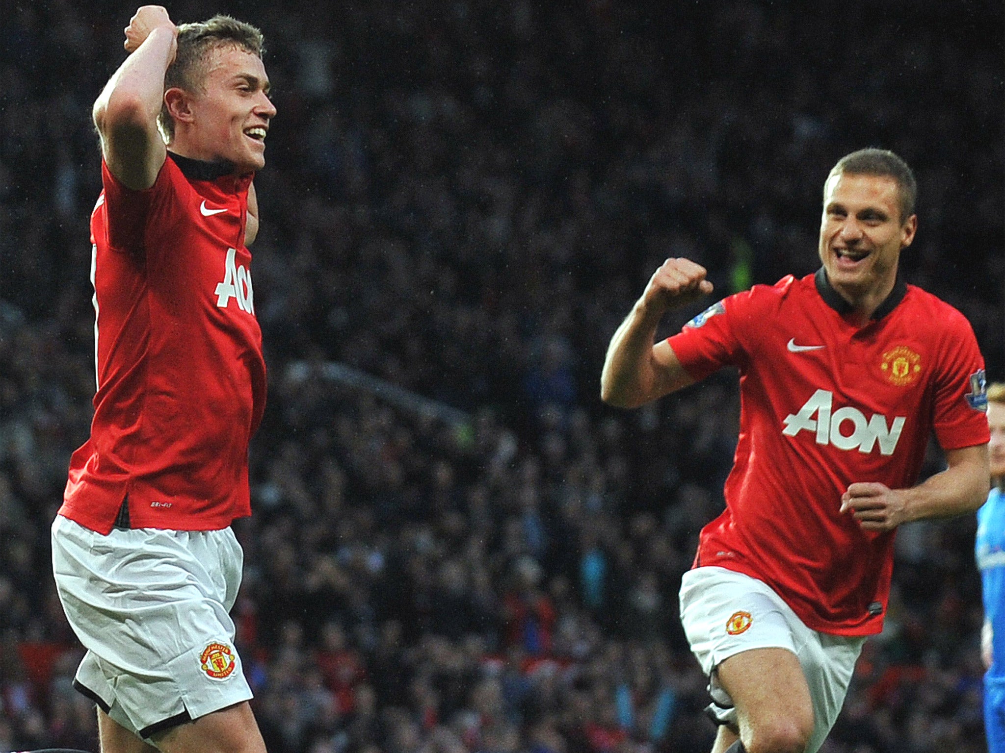James Wilson celebrates with Nemanja Vidic, who was making his last appearance at Old Trafford for United