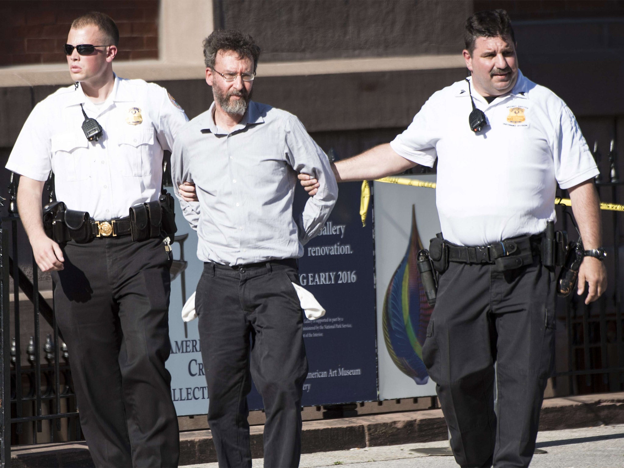 A man is taken into custody by Secret Service officials