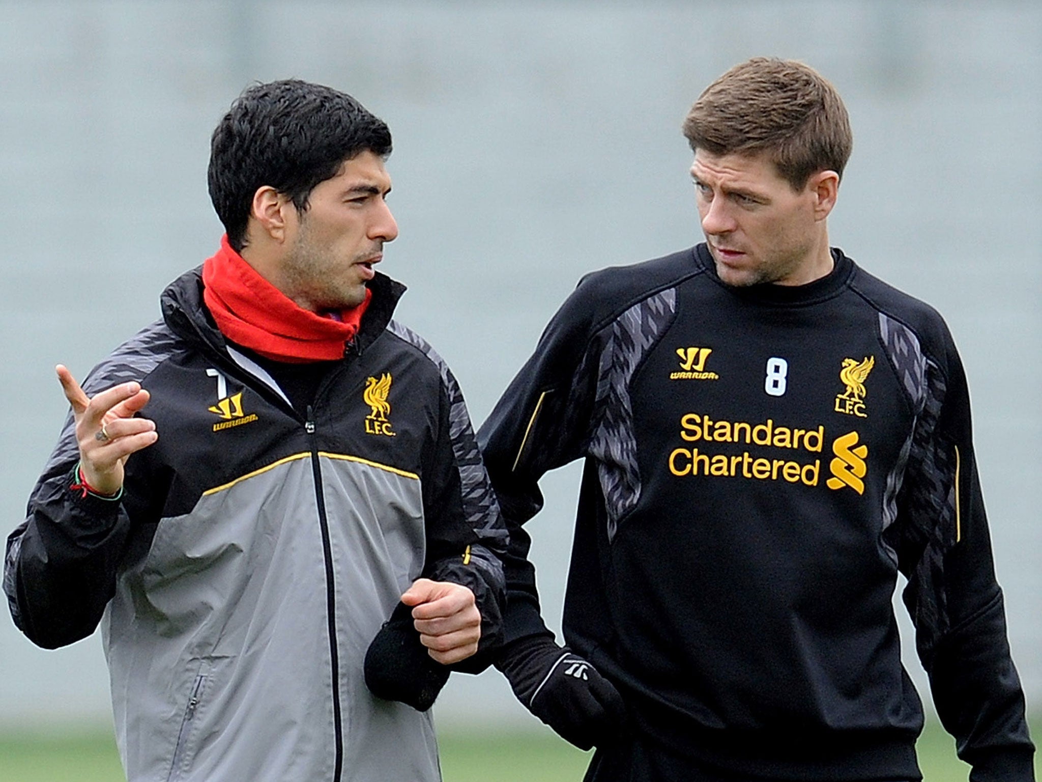 Luis Suarez (left) and Steven Gerrard talk during Liverpool training