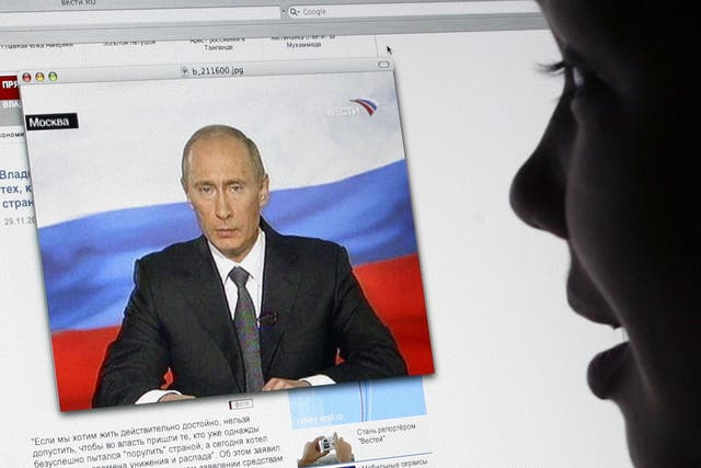 A girl watches Russian President Vladimir Putin's address to the nation on Russsian TV Channel One's website