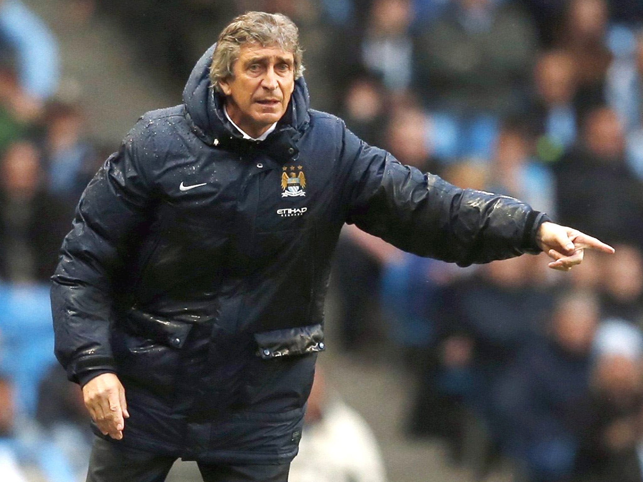 Manchester City boss Manuel Pellegrini urges his troops on