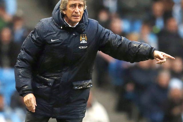 Manchester City boss Manuel Pellegrini urges his troops on
