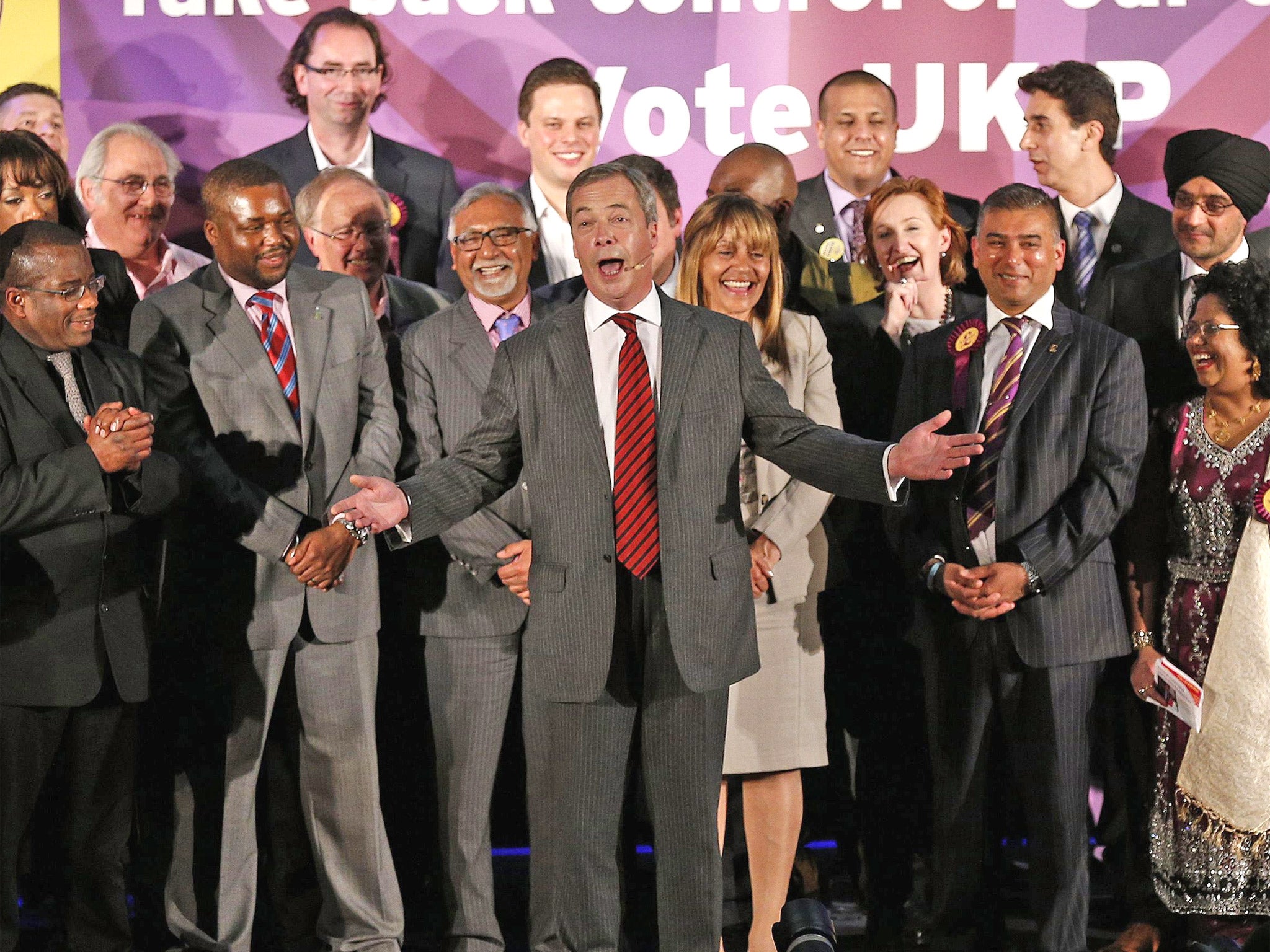 Nigel Farage (centre) speaks on stage during a Ukip rally held at the Emmanuel Centre, London