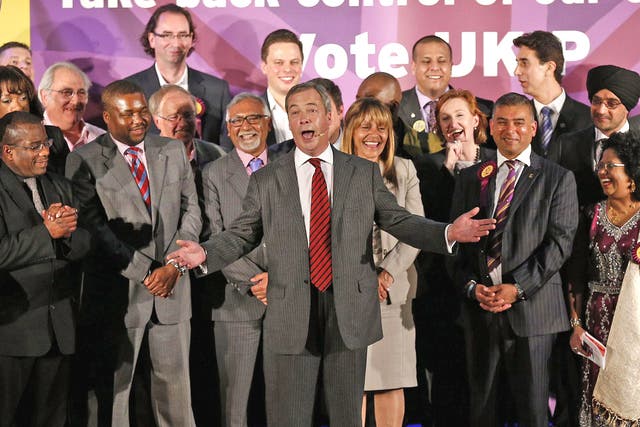 Nigel Farage (centre) speaks on stage during a Ukip rally held at the Emmanuel Centre, London