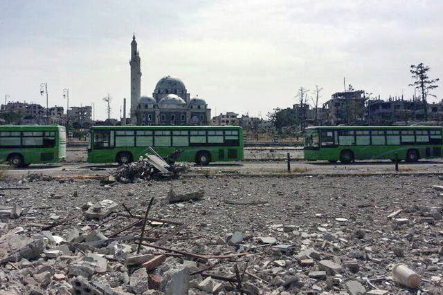 Buses carrying Free Syrian Army fighters leaving Homs