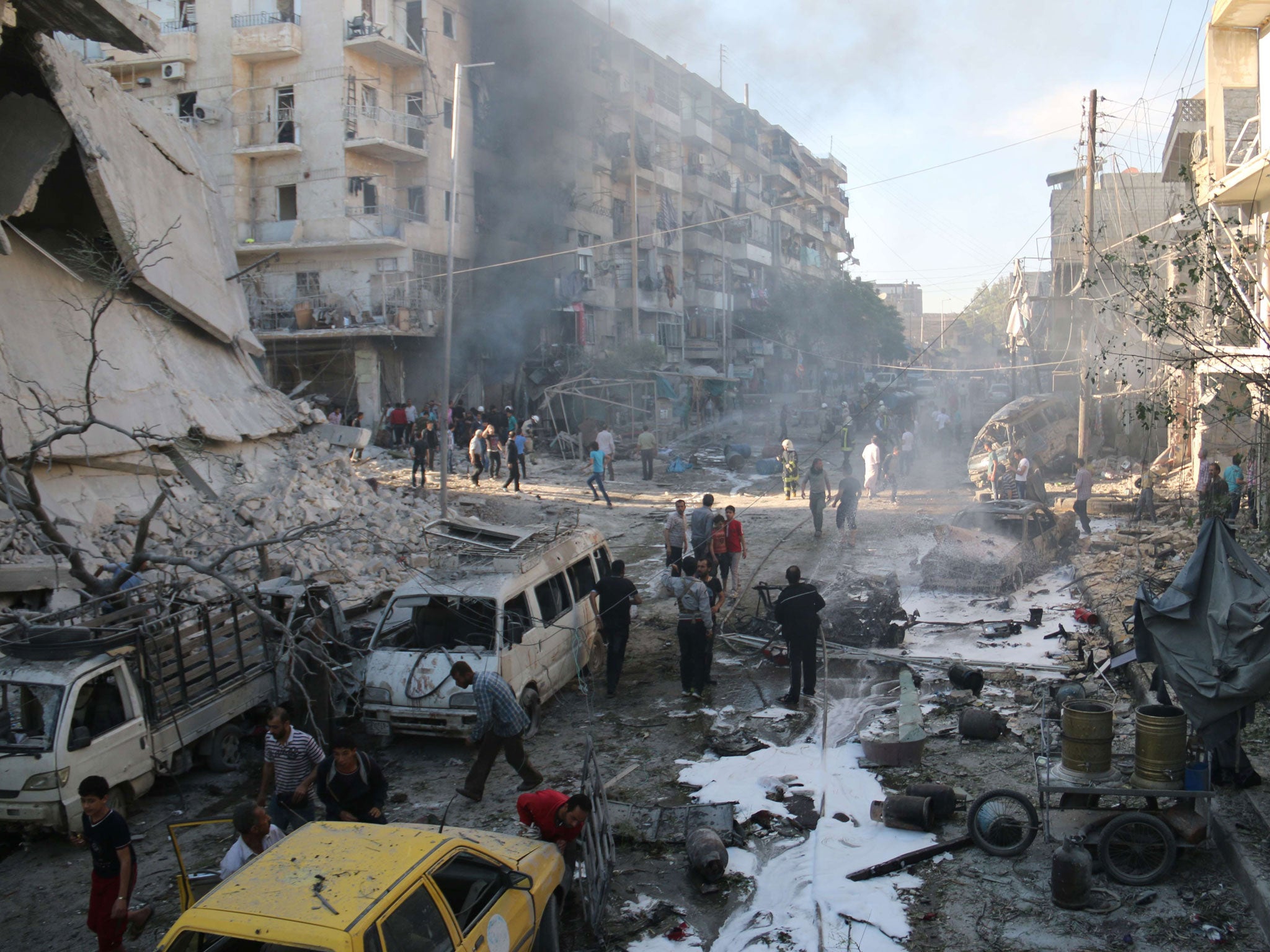 Syrians gather at the site of reported air strikes by government forces in the Halak neighbourhood in northeastern Aleppo