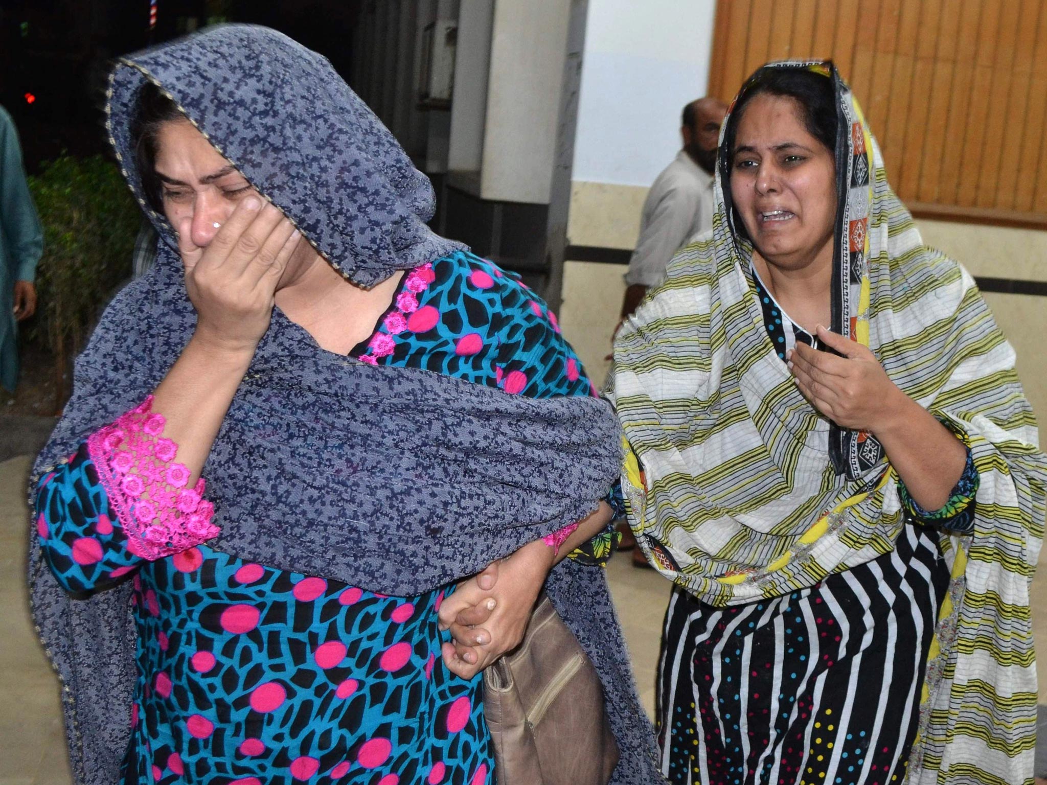Pakistani relatives mourn after the killing of lawyer Rashid Rehman, at a hospital following an attack by gunmen in Multan