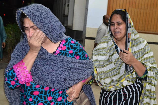 Pakistani relatives mourn after the killing of lawyer Rashid Rehman, at a hospital following an attack by gunmen in Multan