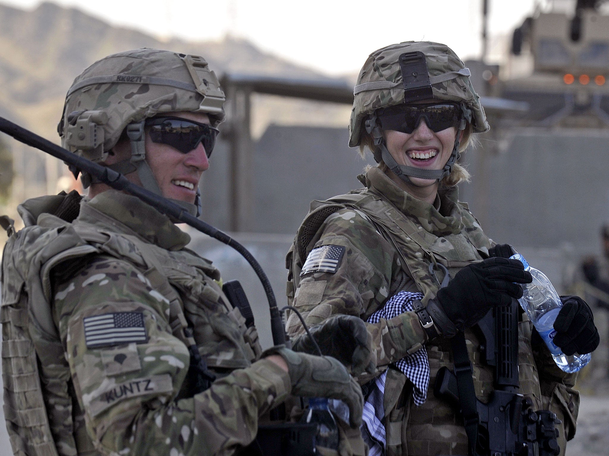 US army officers Kris Kuntz (L) and Hayley Barner talk in Afghanistan. Soon, UK female troops may be able to serve in 'close combat' positions.