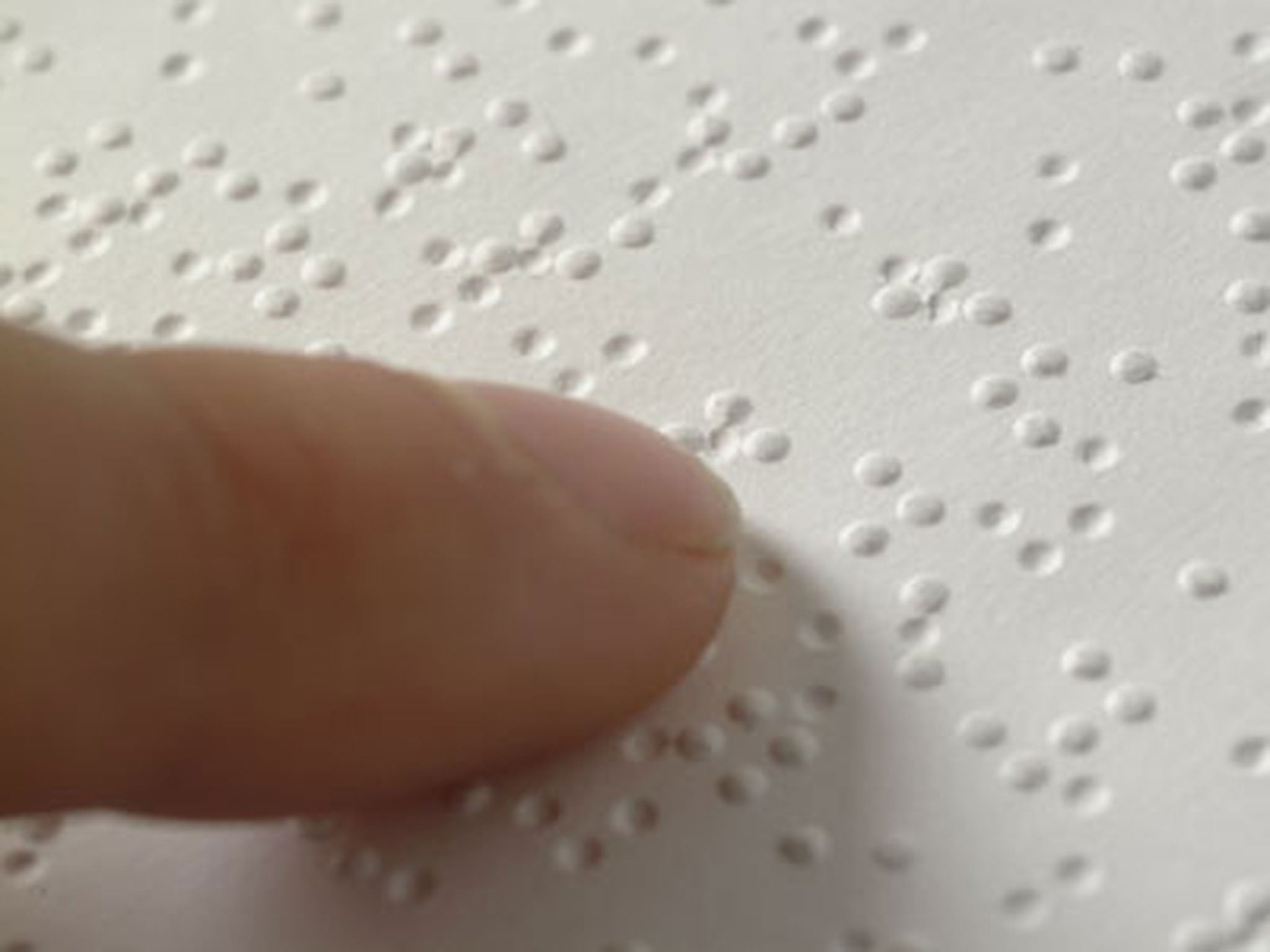A blind person uses braille to read