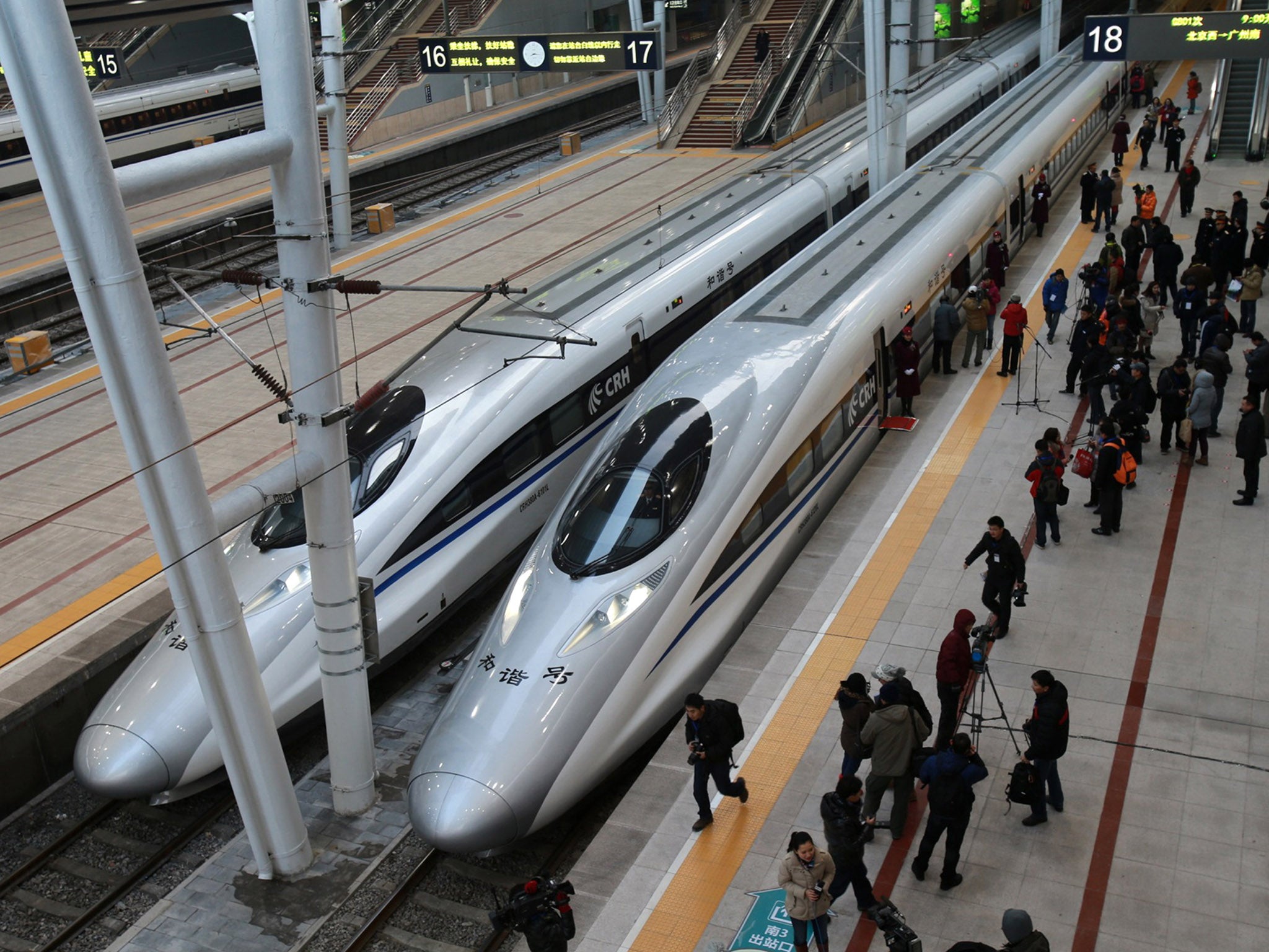 Trains stand in Beijing railway station preparing to set off on the world's longest high-speed rail route which travels 1,425-miles to Guangzhou in the south of the country