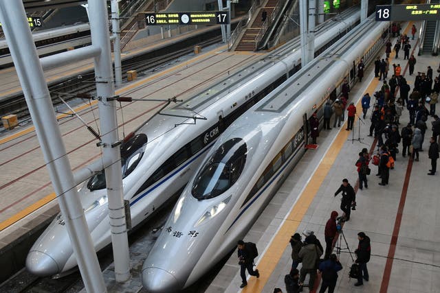 Trains stand in Beijing railway station preparing to set off on the world's longest high-speed rail route which travels 1,425-miles to Guangzhou in the south of the country 