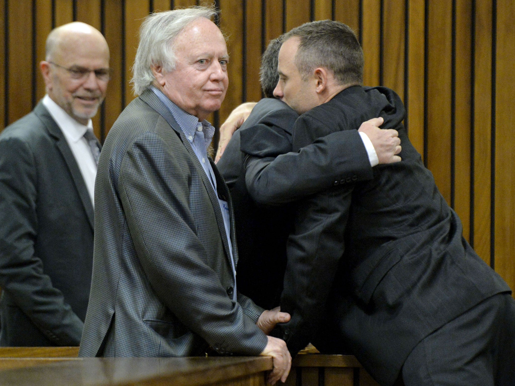 Oscar Pistorius (R) is greeted by his family at the Pretoria High Court on May 9, 2014, in Pretoria, South Africa