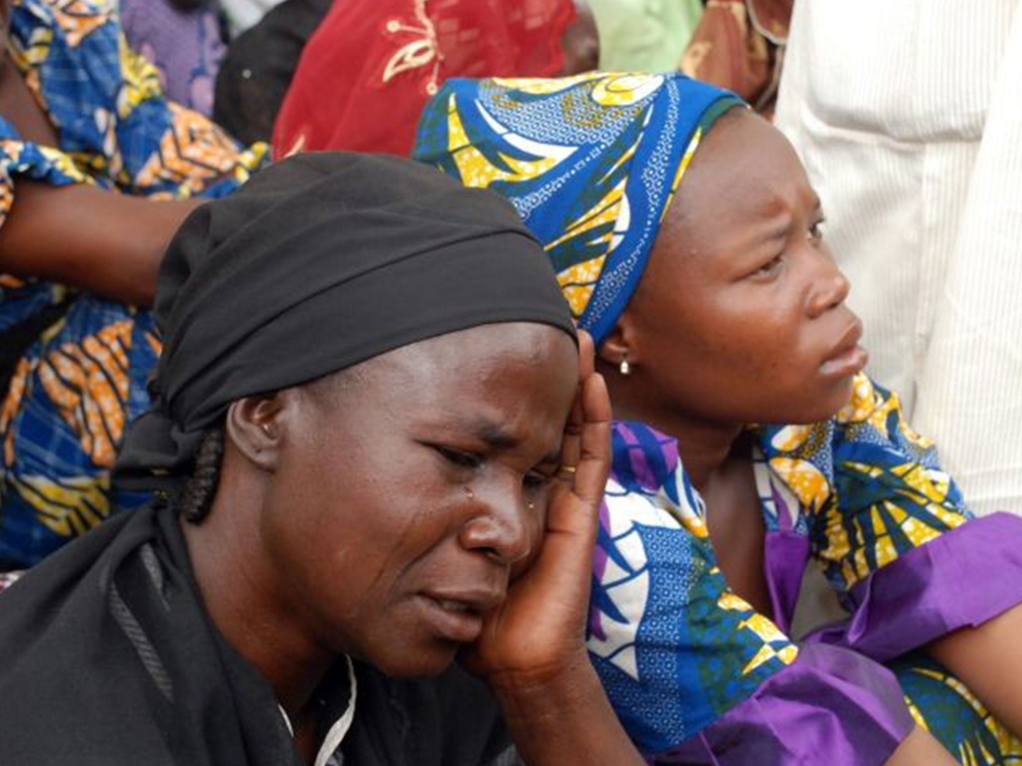 Mothers of the missing Chibok school girls abducted by Boko Haram Islamists gather to receive information from officials