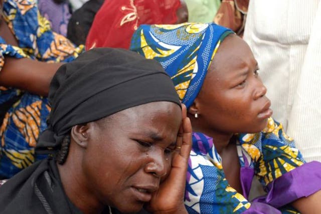 Mothers of the missing Chibok school girls abducted by Boko Haram Islamists gather to receive information from officials