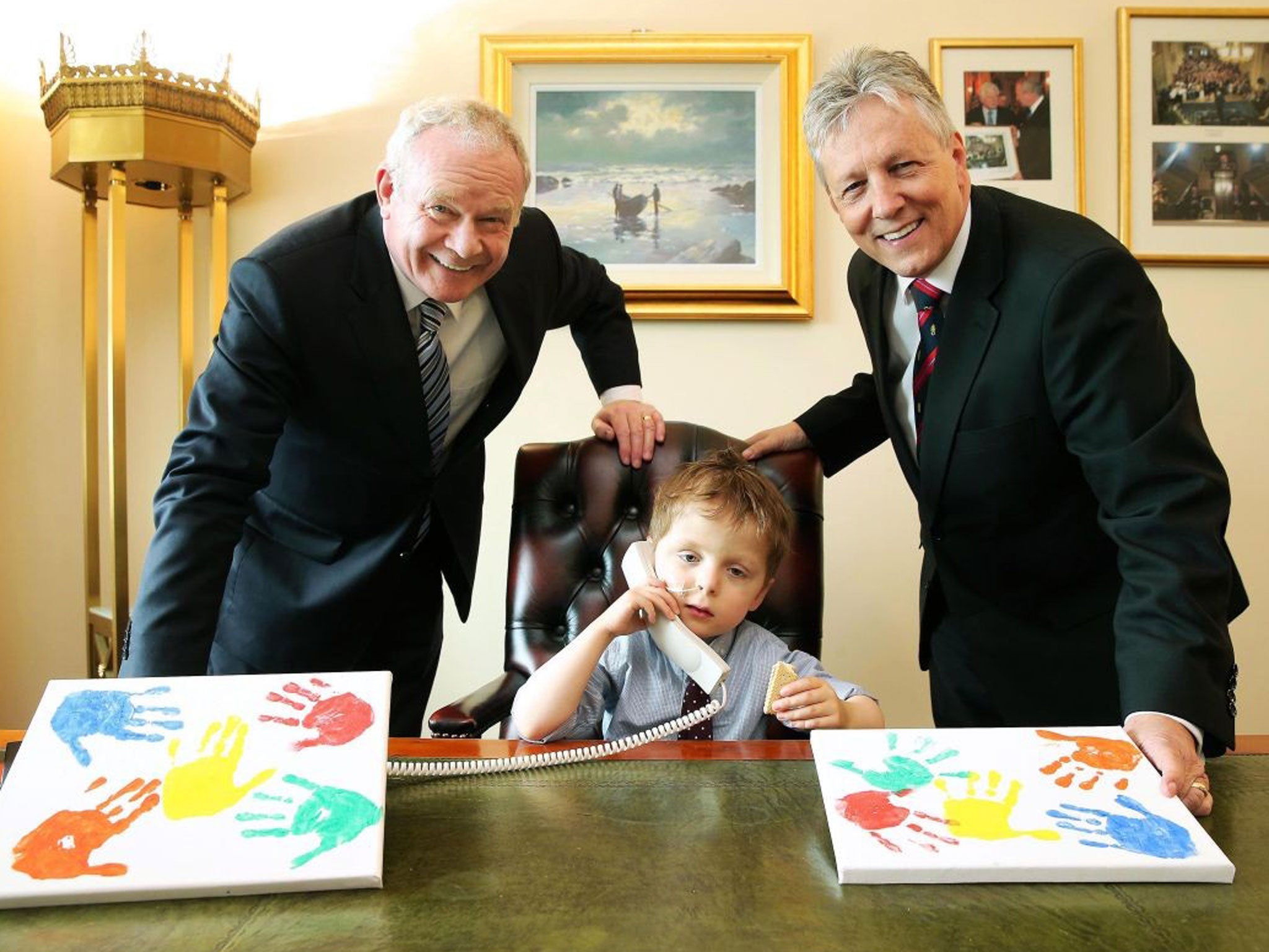 Handout photo dated 01/07/13 issued by Press Eye of Oscar Knox with First Minister Peter Robinson (right) and deputy First Minister Martin McGuinness at Parliament Buildings in Belfast as Oscar has died aged five.