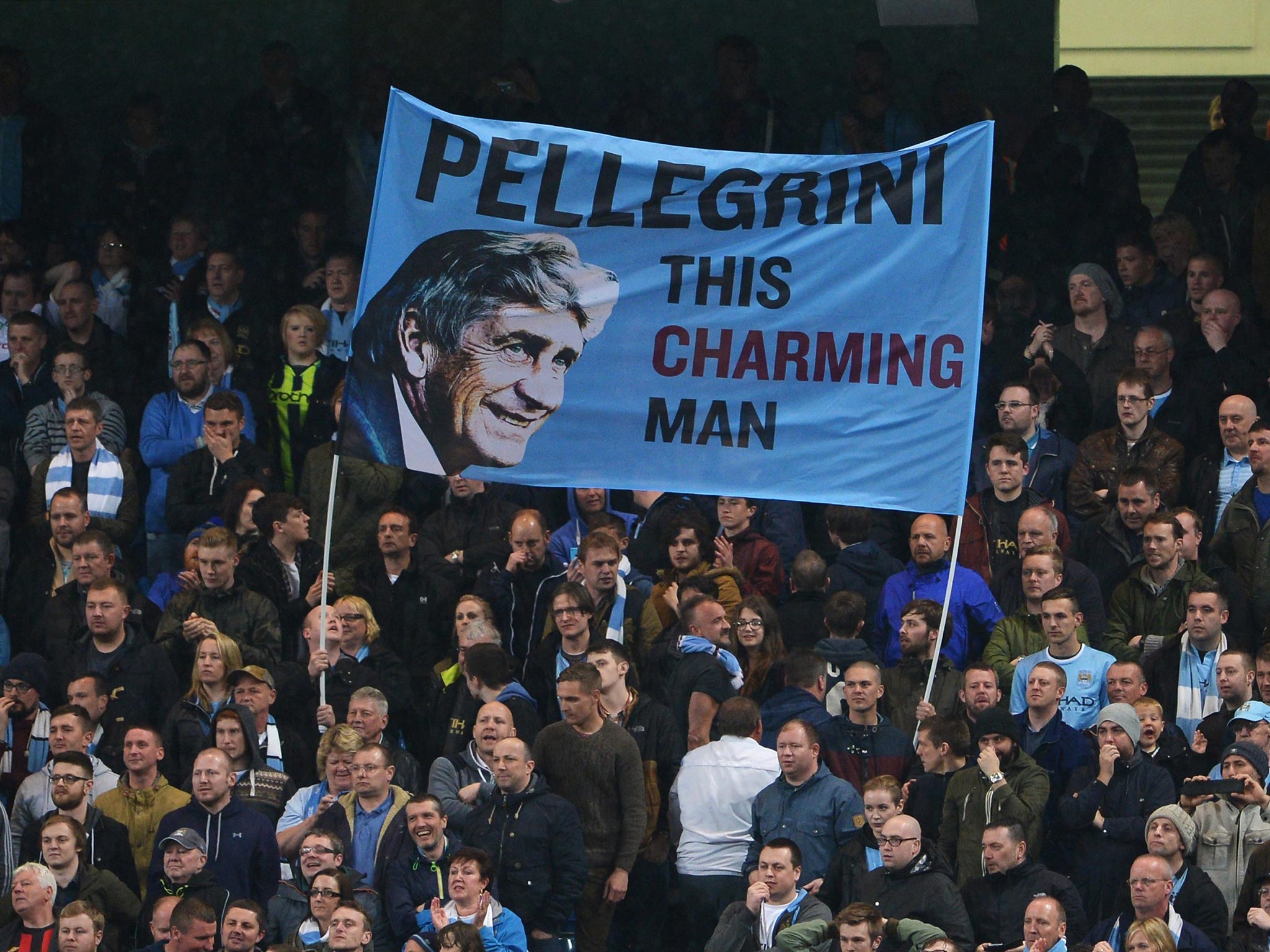 Manchester City fans fly a flag for Manuel Pellegrini, manager of Manchester City