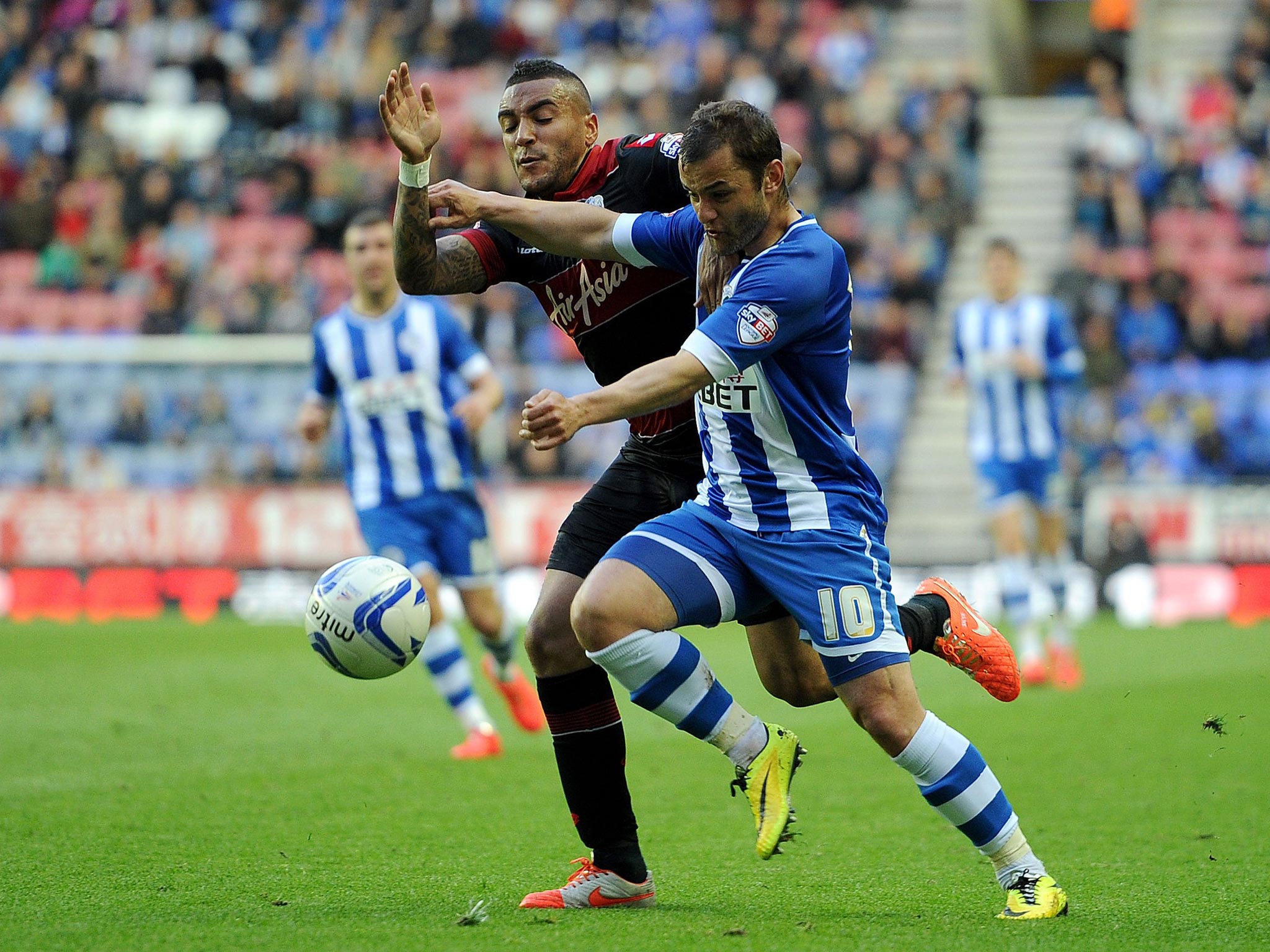 Wigan Athletic's Shaun Maloney battles for the ball with Queens Park Rangers Danny Simpson