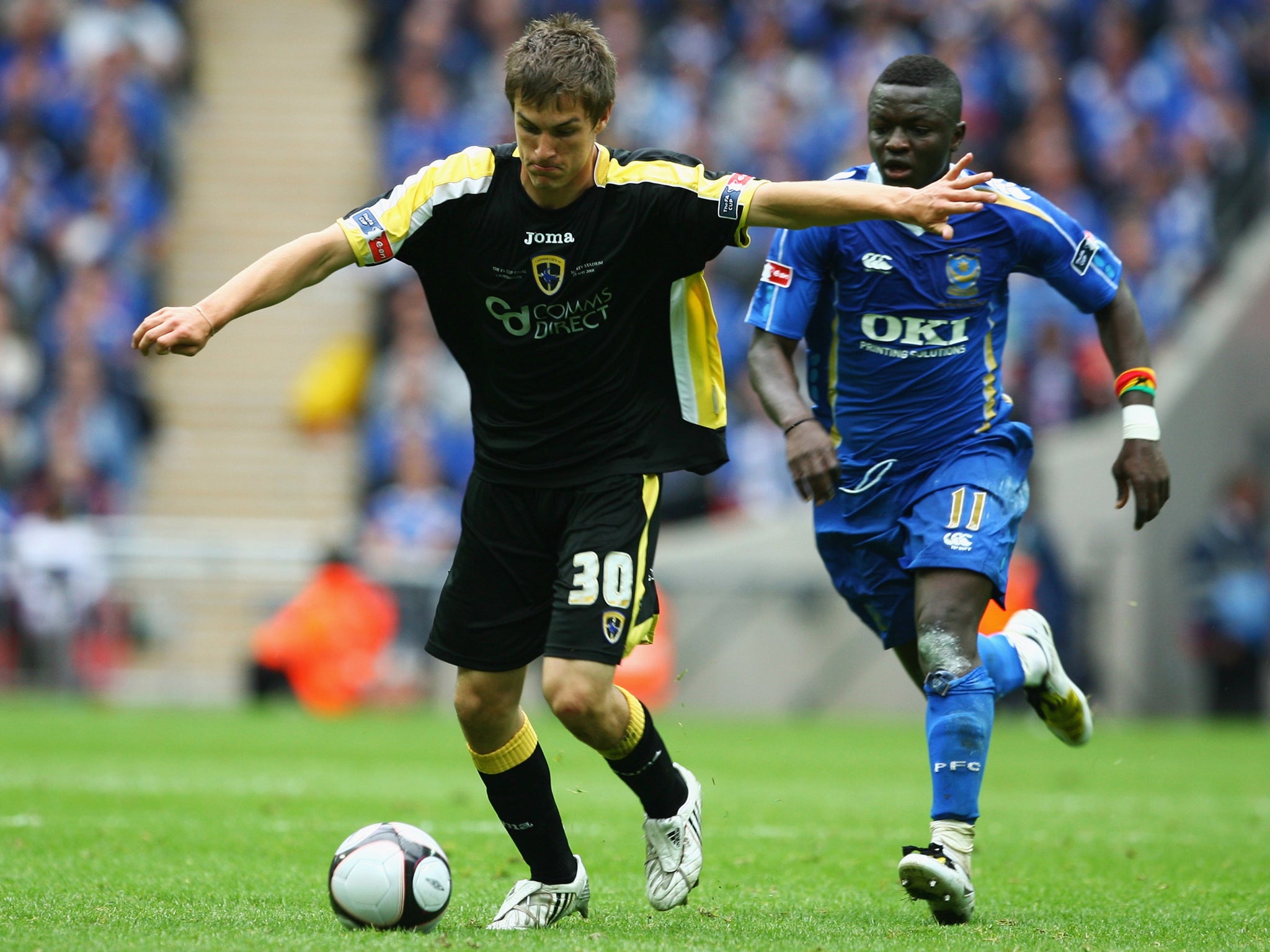 Aaron Ramsey in action in the 2008 FA Cup final for Cardiff as he battles with Portsmouth's Sulley Muntari