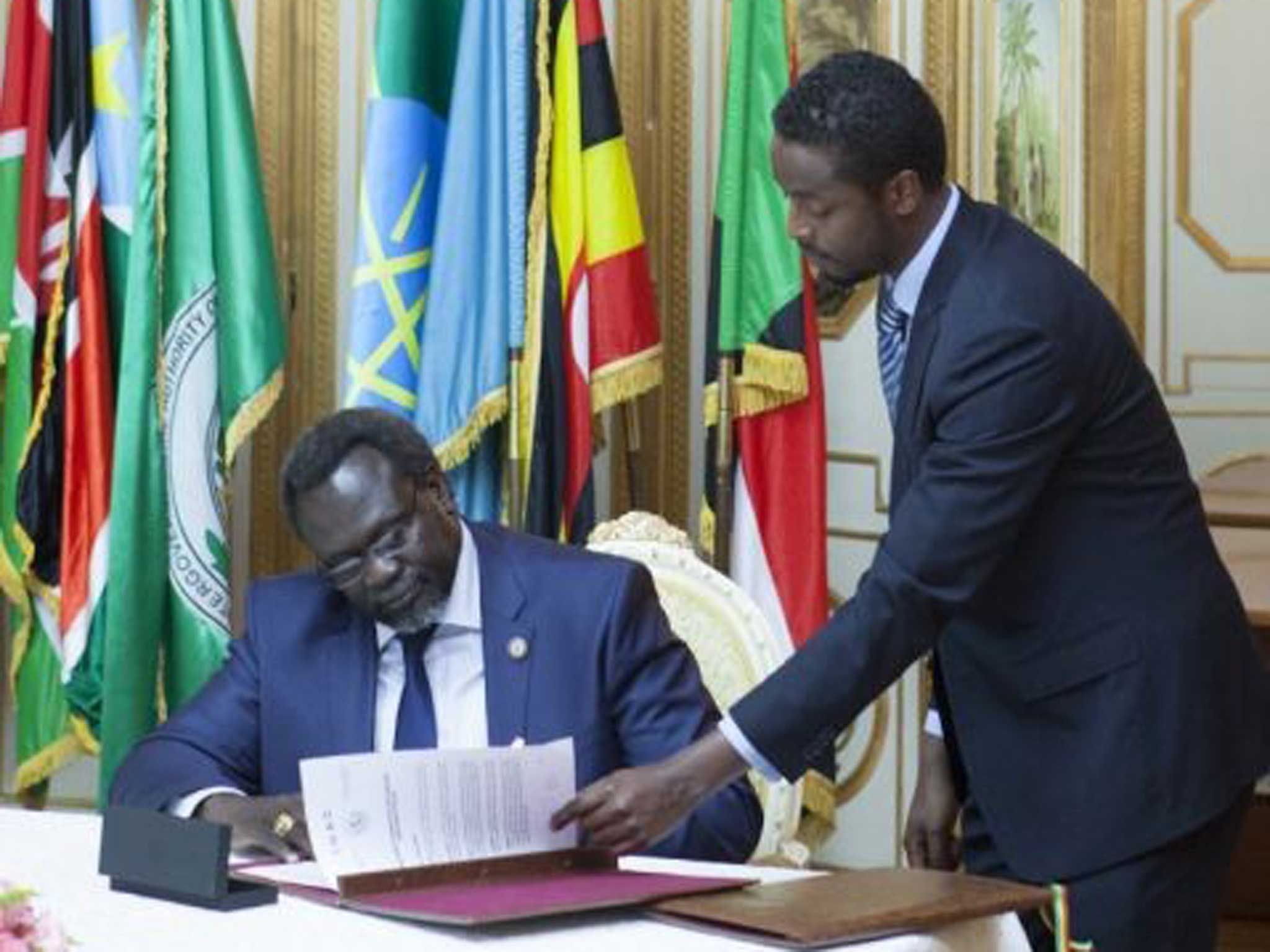 Riek Machar signs the ceasefire on Friday