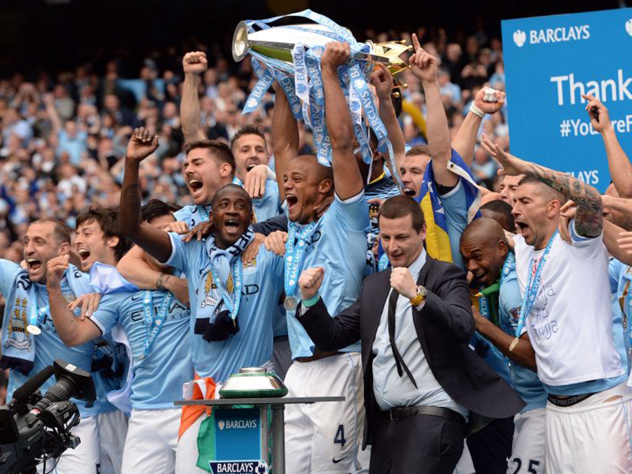 Vincent Kompany holds the Premier League title aloft after Manchester City's win over West Ham