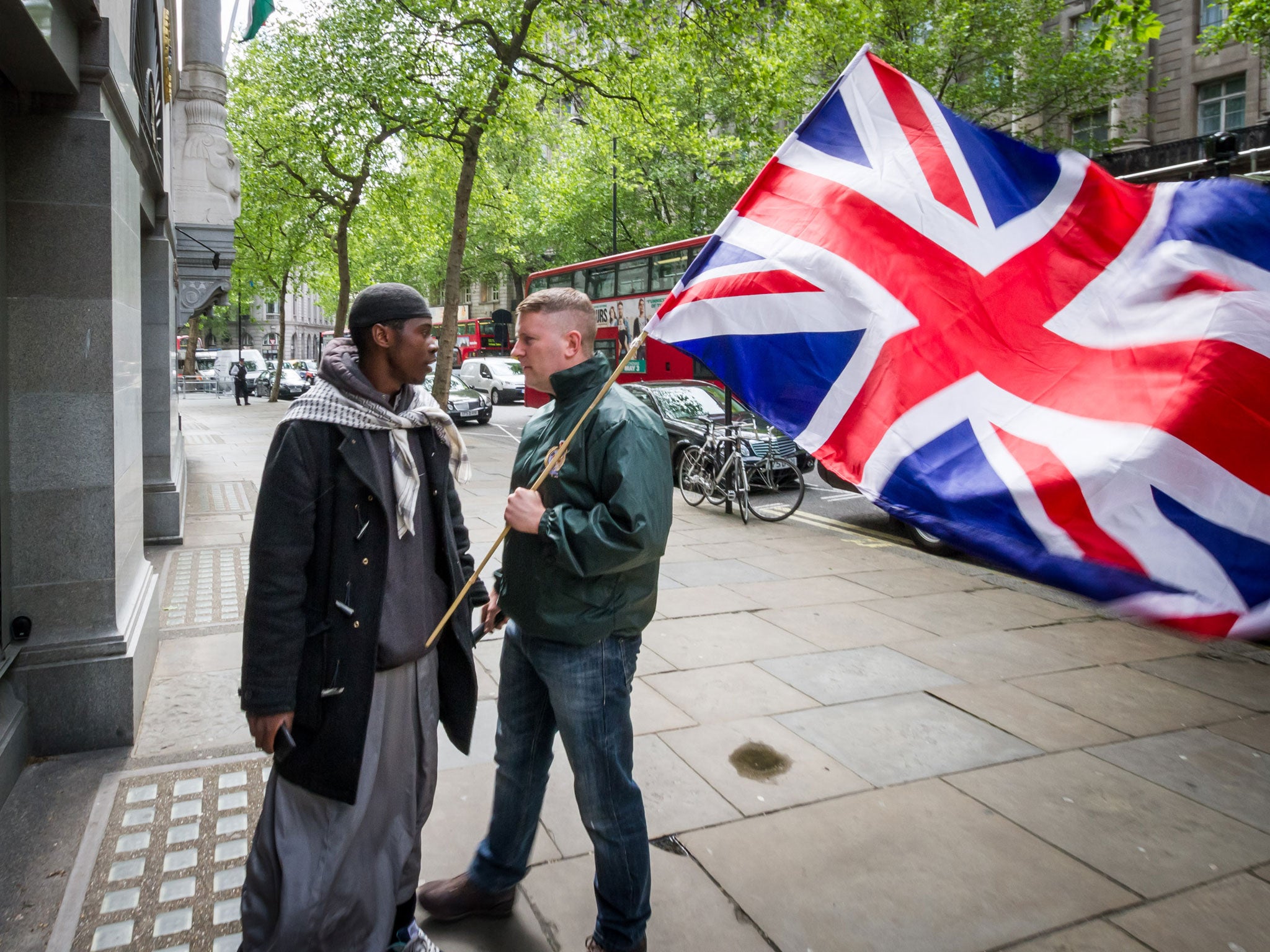 Paul Golding, right, leader of the patriot group 'Britain First', confronts an Islamist outside the High Commission of India in London