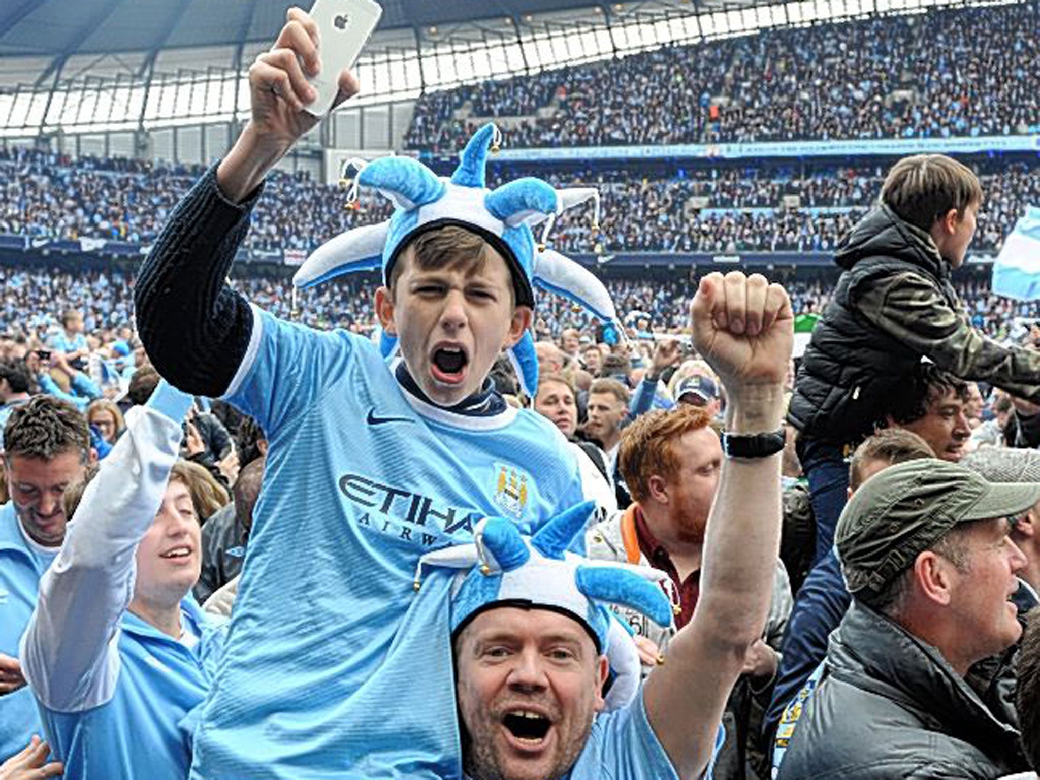 Manchester City fans celebrated their title triumph by flooding on to the pitch at the Etihad Stadium yesterday