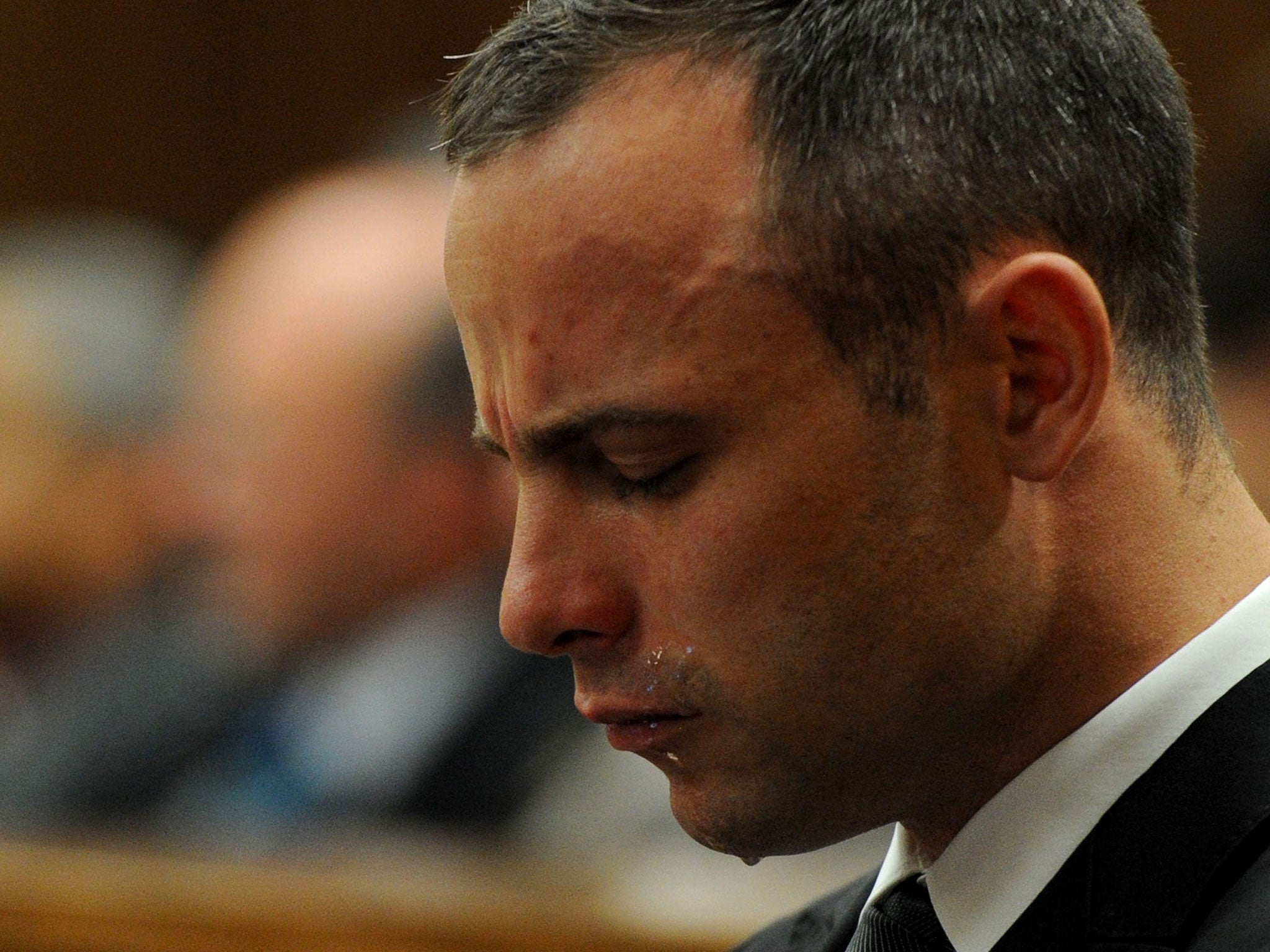 Oscar Pistorius cries during his ongoing murder trial, at the high court in Pretoria