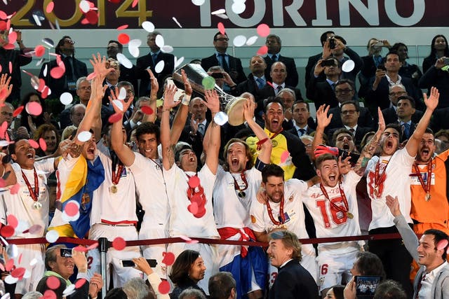 Ivan Rakitic raises the Europa league trophy as Sevilla are crowned champions