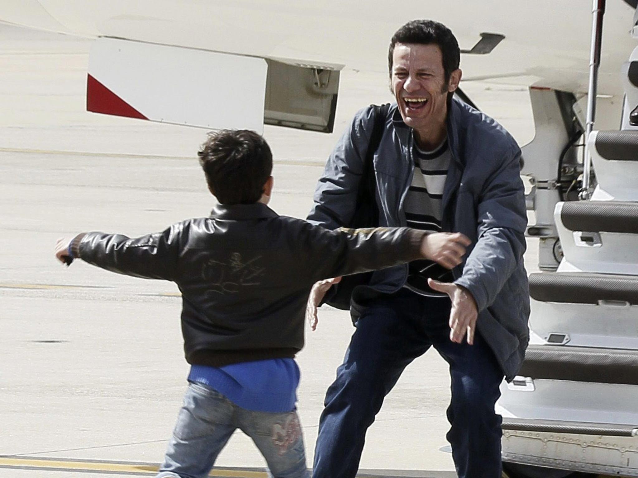 Reunion: El Mundo correspondent Javier Espinosa is greeted by his son in Madrid