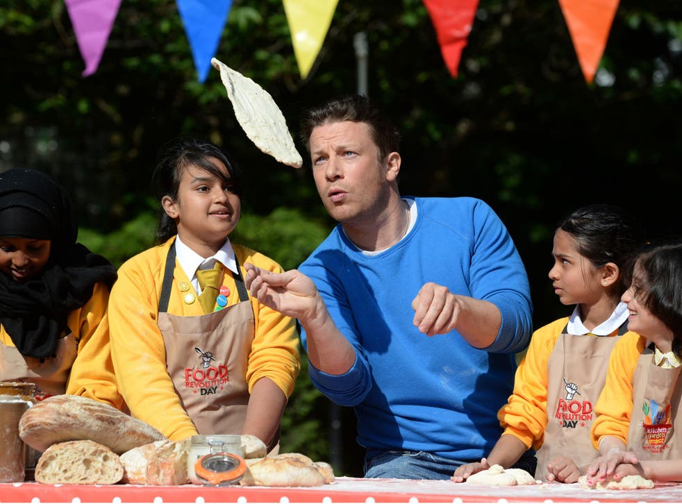 Jamie Oliver joins children as they celebrate Food Revolution Day 2014 by cooking bread, making smoothies and creating salads at St Paul's Whitechapel CE Primary School in London 