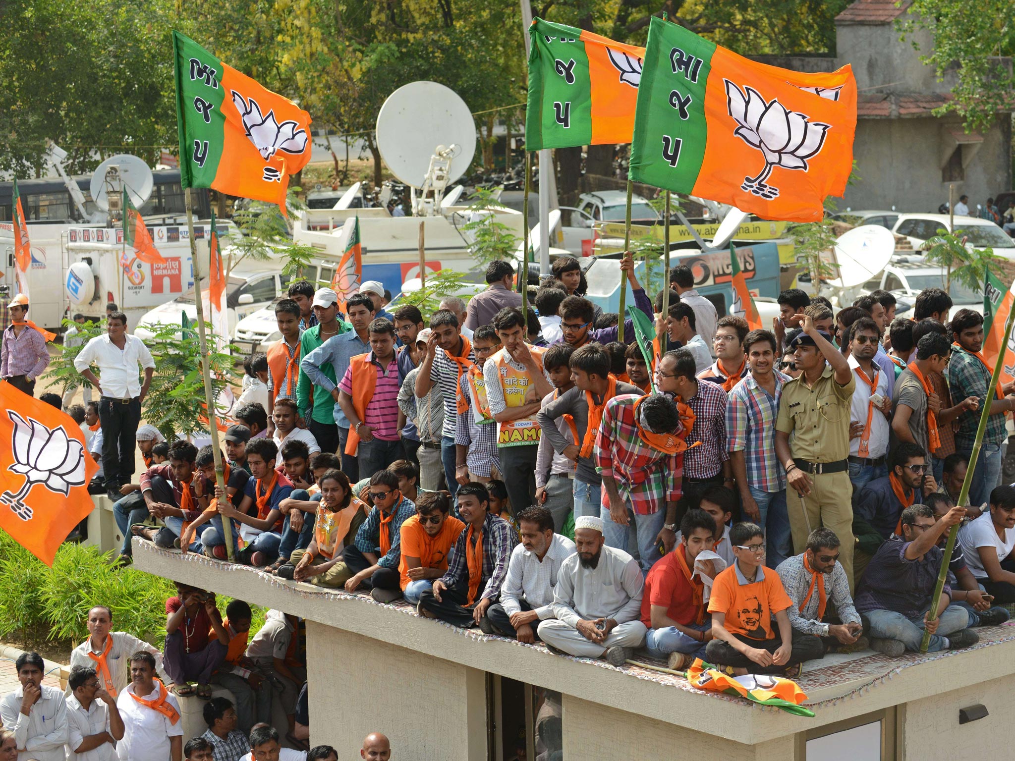 Indian Bharatiya Janata Party (BJP) supporters wait for the arrival of Narendra Modi