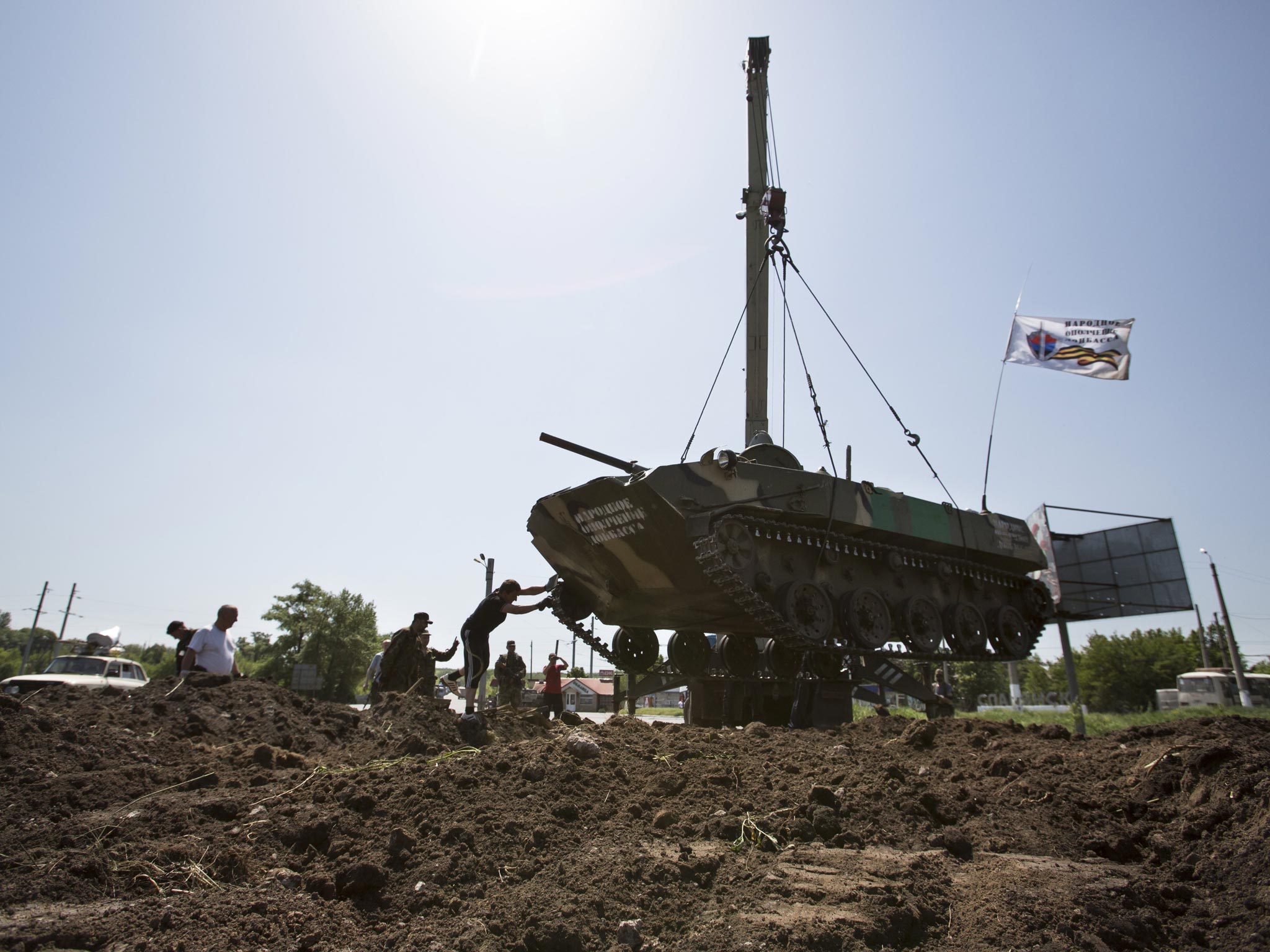 Pro-Russian militants take their positions using an armored personnel carrier preparing to fight against Ukrainian government troops outside Slovyansk, eastern Ukraine