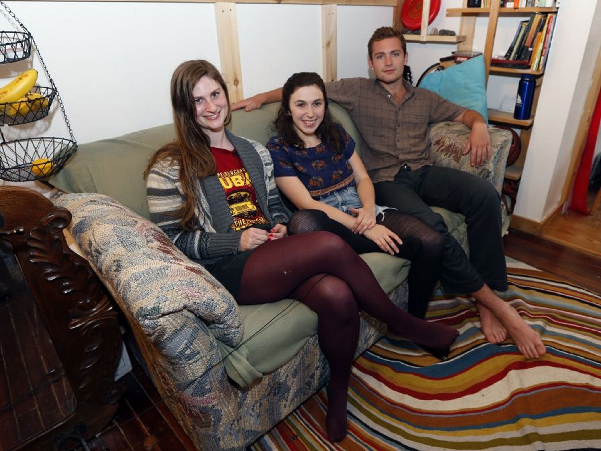 From left, Lara Russo, Cally Guasti and Reese Werkhoven sit on a couch in their apartment