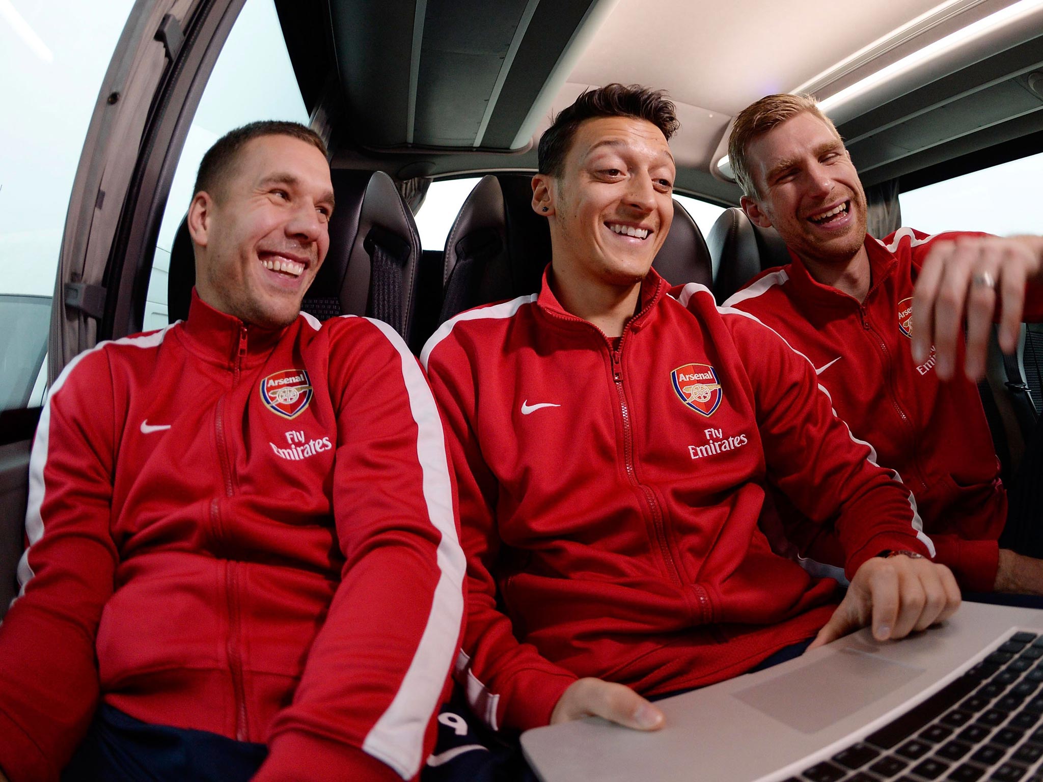 Left to right: Lukas Podolski, Mesut Özil and Per
Mertesacker share a joke