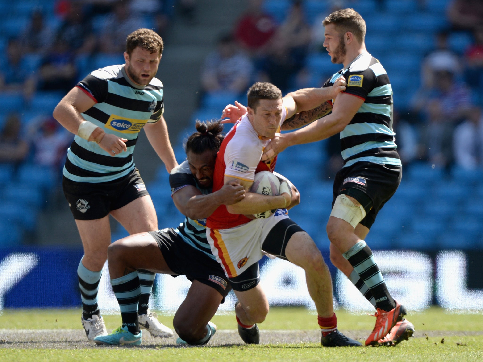 Ben Pomeroy of Catalan Dragons tries to break the london line during the Super League match between London Broncos and Catalan Dragons at Etihad Stadium