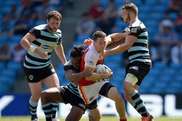 Ben Pomeroy of Catalan Dragons tries to break the london line during the Super League match between London Broncos and Catalan Dragons at Etihad Stadium 