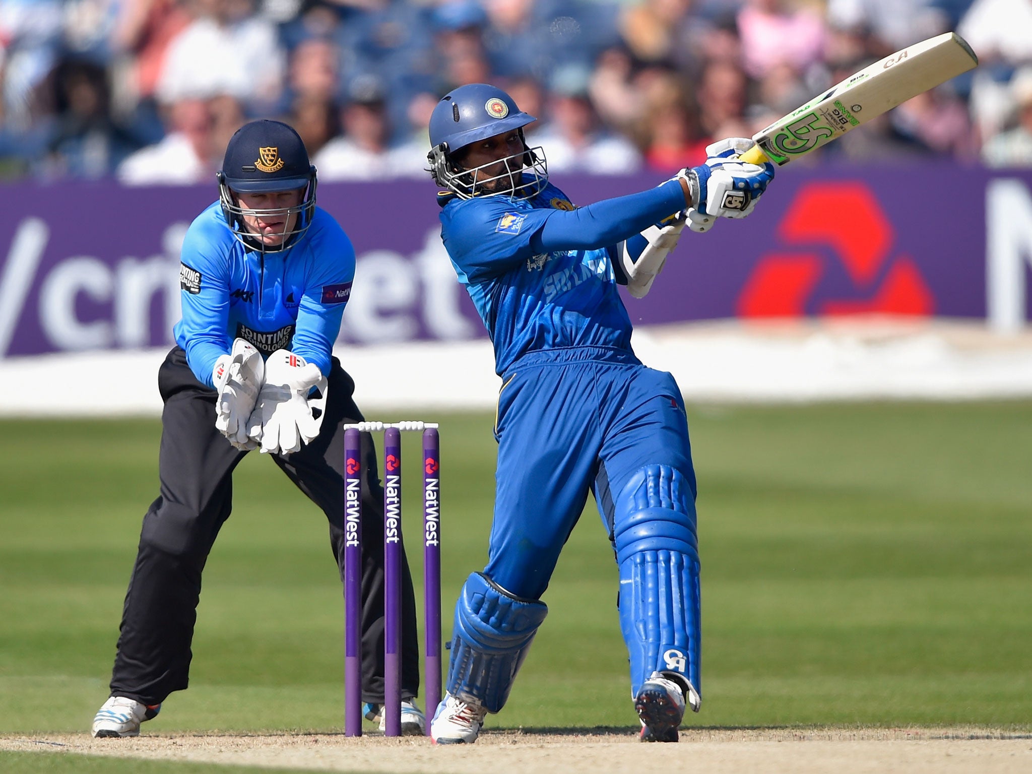 Tillekeratne Dilshan of Sri lanka smashes a boundary as wicketkeeper Ben Brown of Sussex looks on