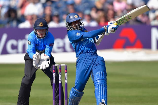 Tillekeratne Dilshan of Sri lanka smashes a boundary as wicketkeeper Ben Brown of Sussex looks on