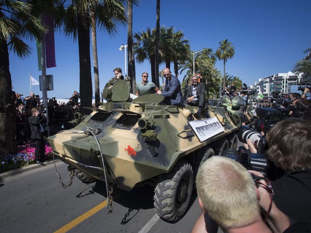 Dolph Lundgren, Jason Statham and Harrison Ford arrive in Cannes on a tank