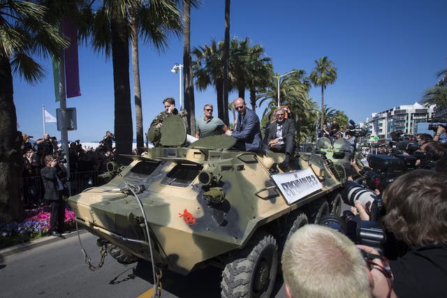 Dolph Lundgren, Jason Statham and Harrison Ford arrive in Cannes on a tank