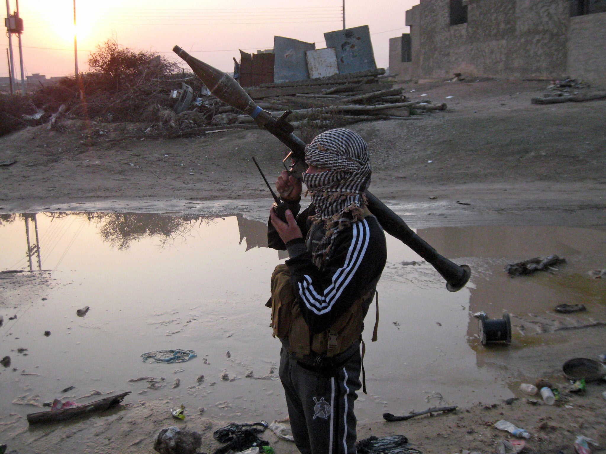 A gunman makes a radio call in rebel-held Fallujah, just west of Baghdad in Iraq.
