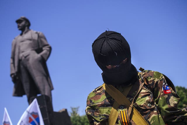 A masked pro-Russian activist attends a separatist rally in the eastern Ukrainian city of Donetsk