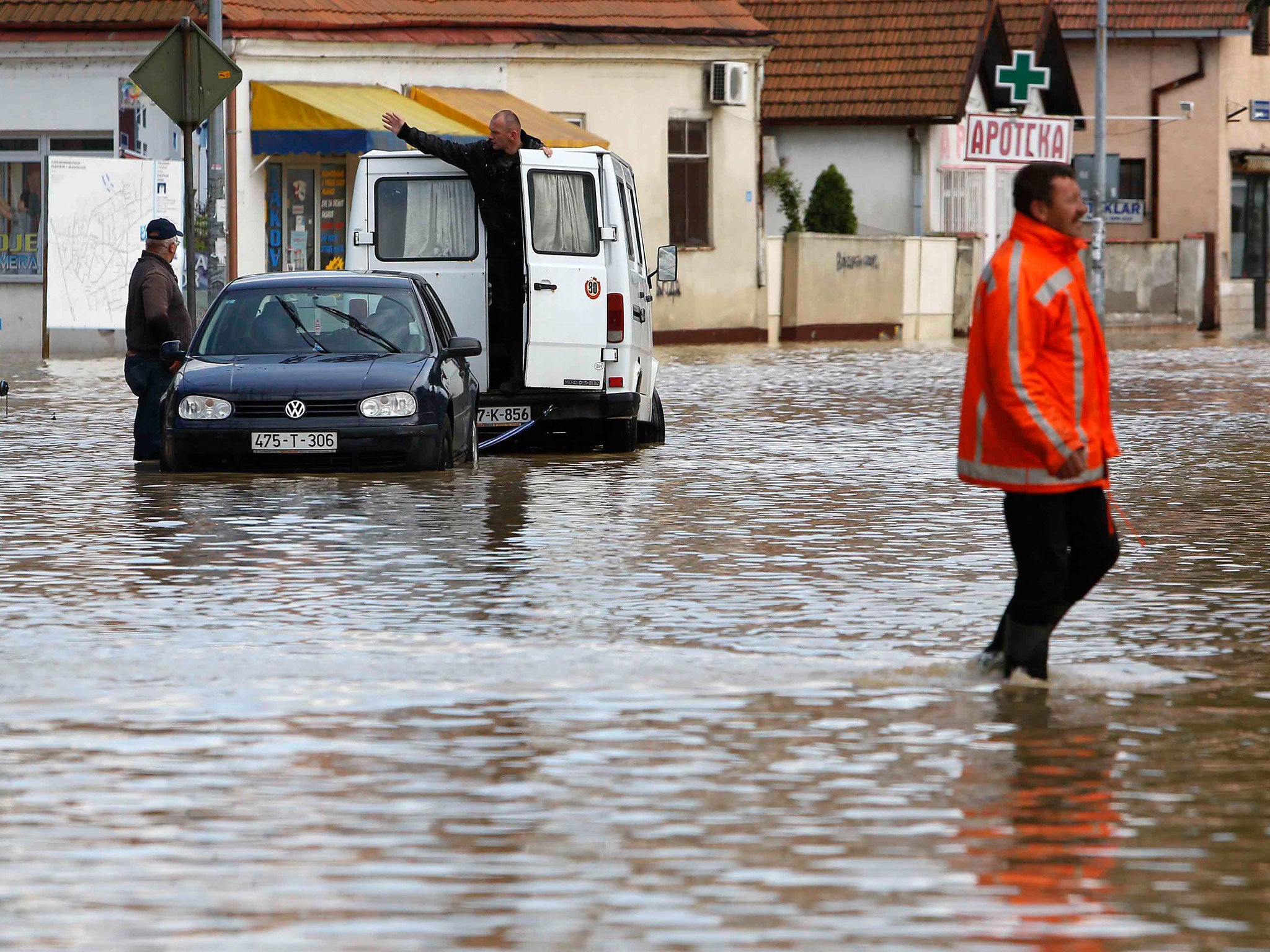 A Bosnian man walks in a flooded street in the Eastern-Bosnian town of Bijeljina