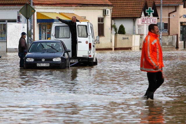 A Bosnian man walks in a flooded street in the Eastern-Bosnian town of Bijeljina