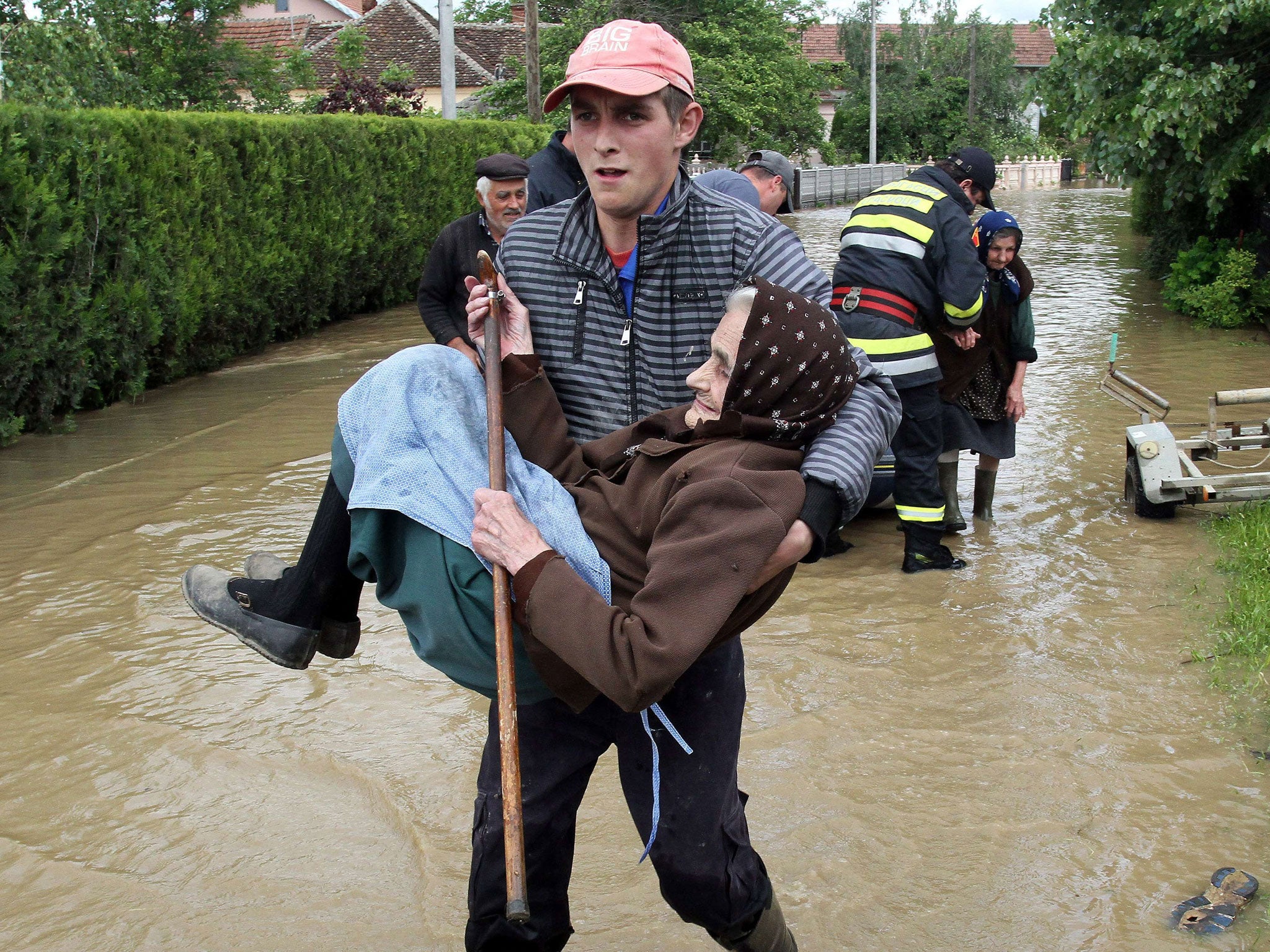 A Serbian rescuer carries an elderly woman out of her flooded house in the village of Obrez, near the central Serbian town of Varvarin, south of Belgrade