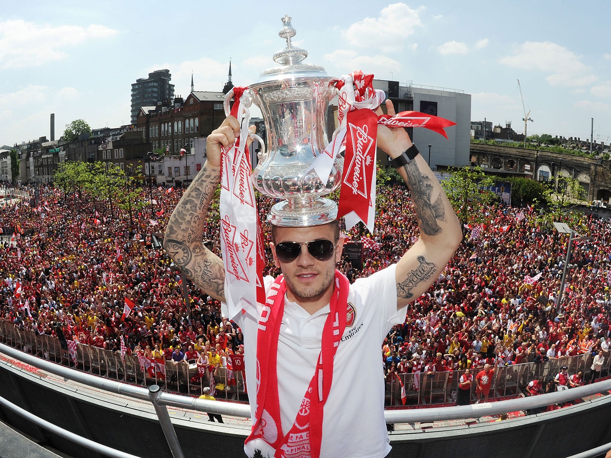 Wilshere poses with the FA Cup trophy at the Arsenal Victory Parade