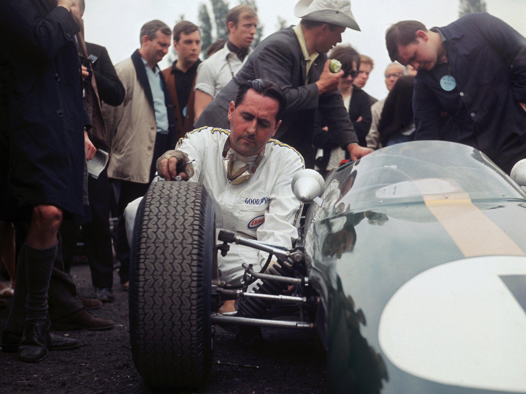 Australian racing driver Jack Brabham checking a tyre on his car at Crystal Palace, London, 1969.
