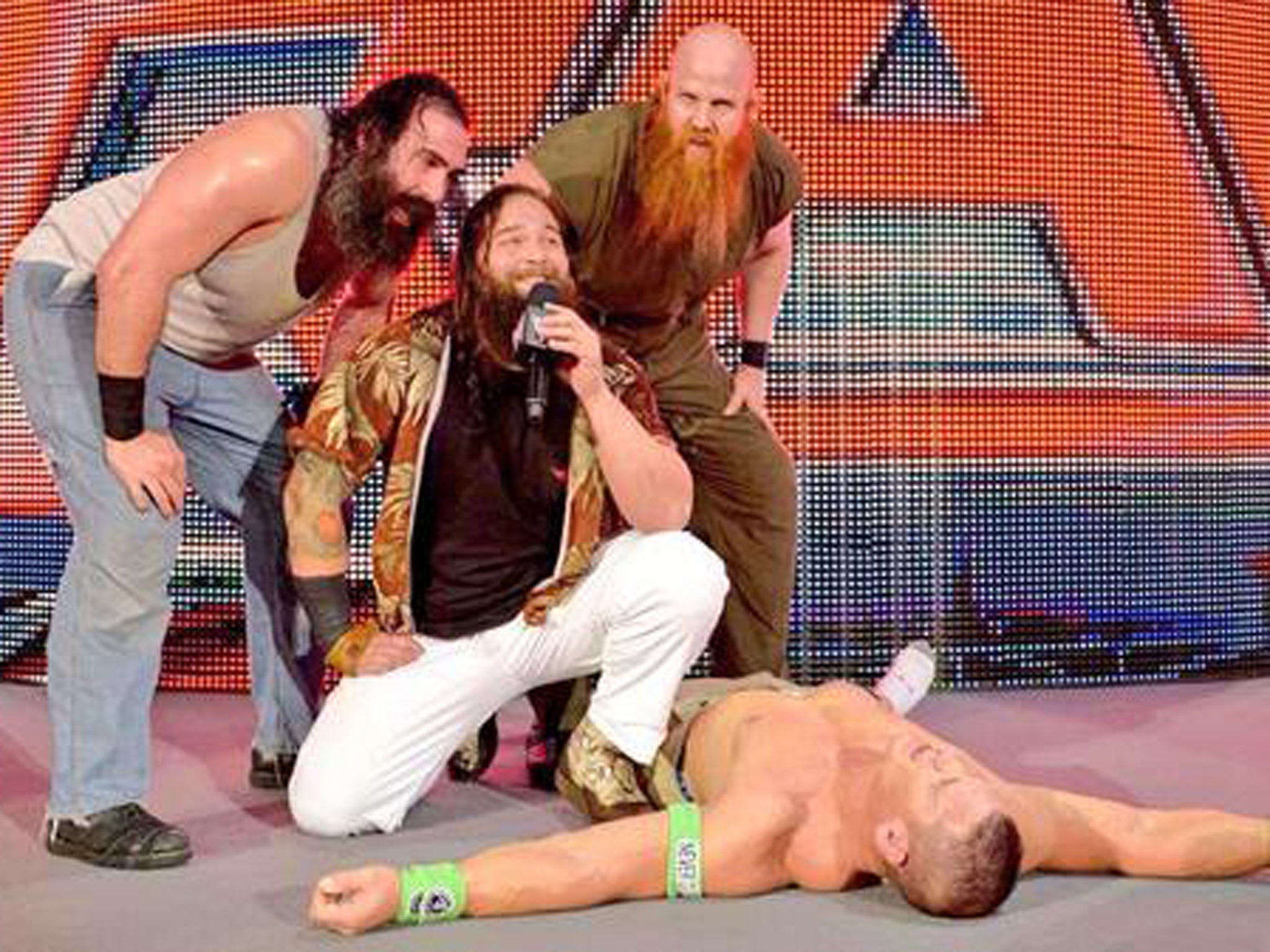 The Wyatt family stand over a beaten John Cena as Raw hits London